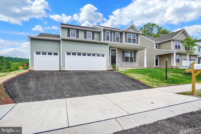 157 Eli Dr, York, PA 17404 - multi unit property with asphalt driveway, a front yard, and an attached garage