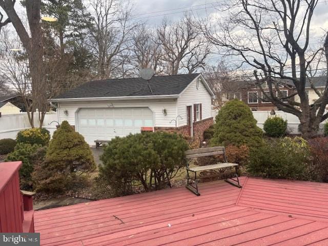 deck featuring fence and an attached garage