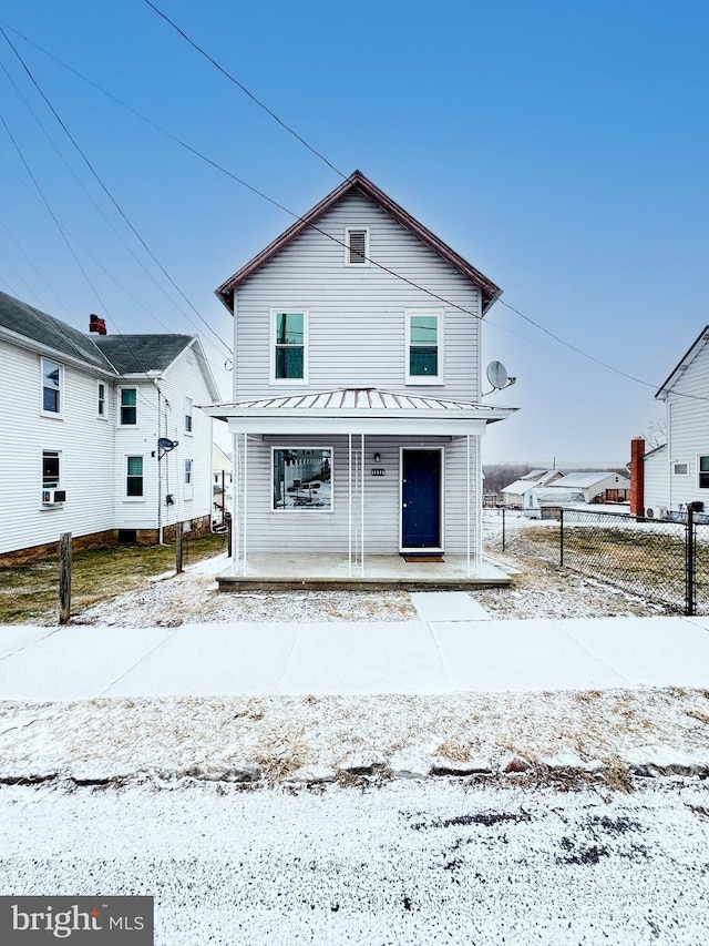 view of front of home with covered porch and fence