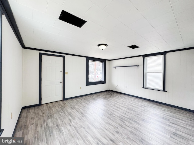 unfurnished bedroom featuring light wood-style flooring, ornamental molding, and baseboards