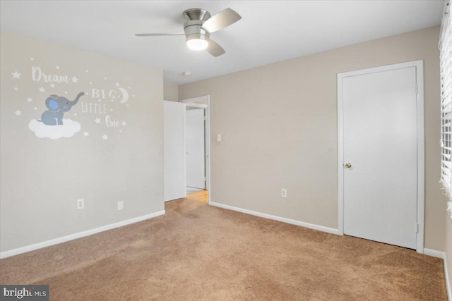 unfurnished bedroom featuring light carpet, ceiling fan, and baseboards
