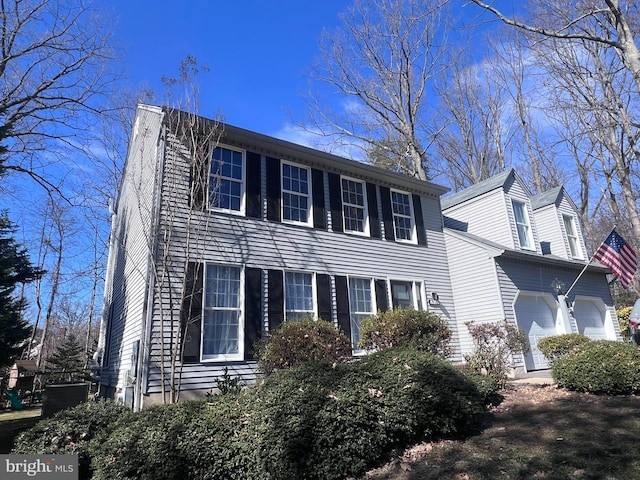 view of front of property featuring an attached garage and a chimney