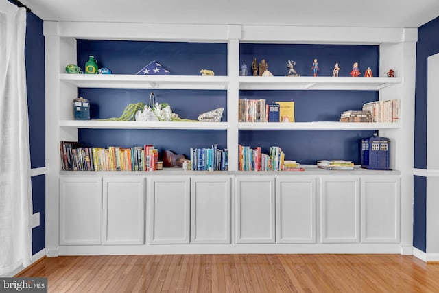 room details with built in shelves, wood finished floors, and baseboards