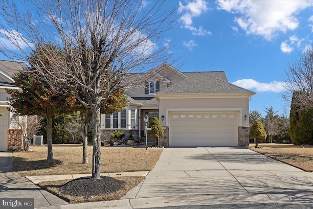 view of front of home featuring a garage, driveway, stone siding, roof with shingles, and stucco siding