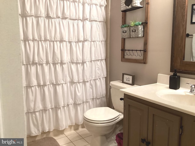 full bathroom featuring vanity, toilet, and tile patterned flooring