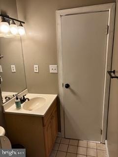 bathroom with vanity, toilet, and tile patterned floors