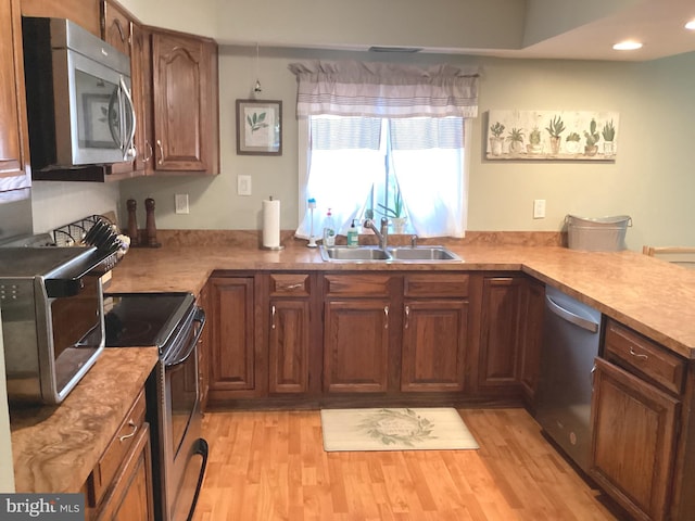 kitchen with light countertops, a sink, and appliances with stainless steel finishes