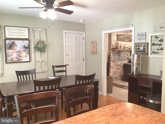 dining room with a ceiling fan and wood finished floors