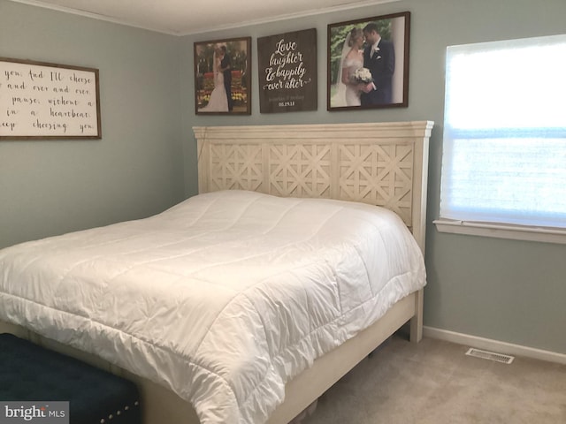 carpeted bedroom featuring visible vents and baseboards