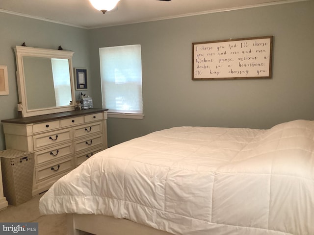 bedroom featuring crown molding and light colored carpet