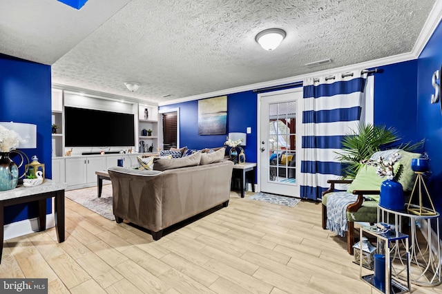 living room with light hardwood / wood-style flooring, crown molding, and a textured ceiling