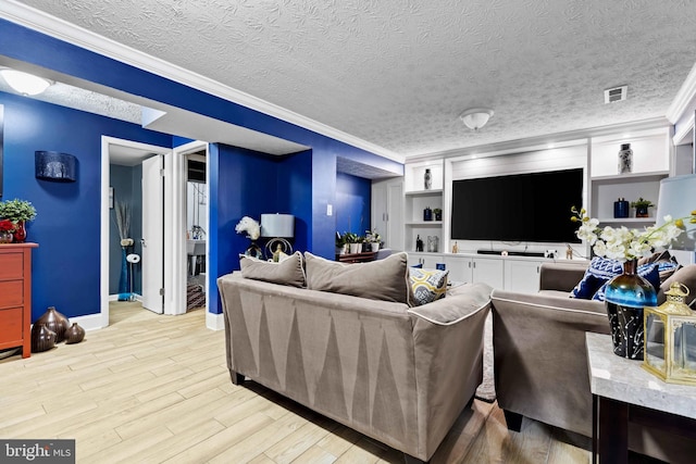 living room featuring light hardwood / wood-style floors, crown molding, built in features, and a textured ceiling