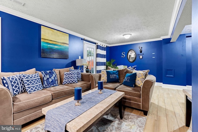 living room with a textured ceiling, hardwood / wood-style floors, and crown molding