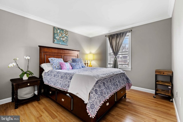 bedroom featuring light hardwood / wood-style flooring and crown molding