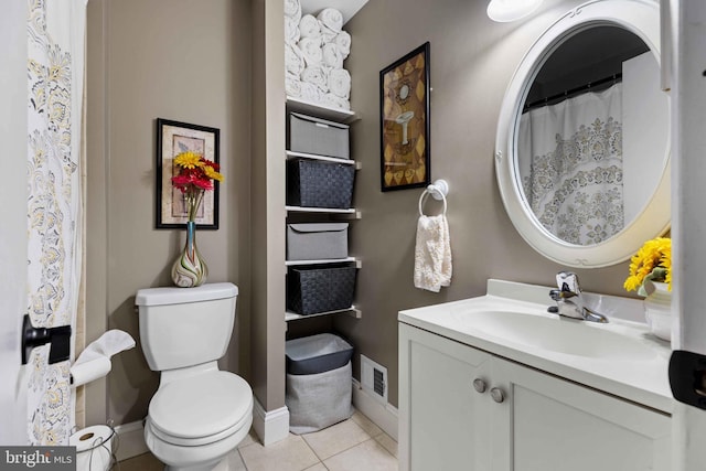 bathroom with tile patterned floors, toilet, and vanity