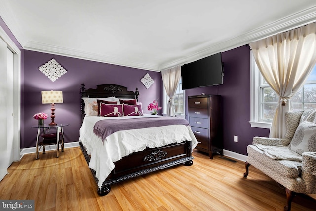 bedroom featuring hardwood / wood-style flooring and crown molding