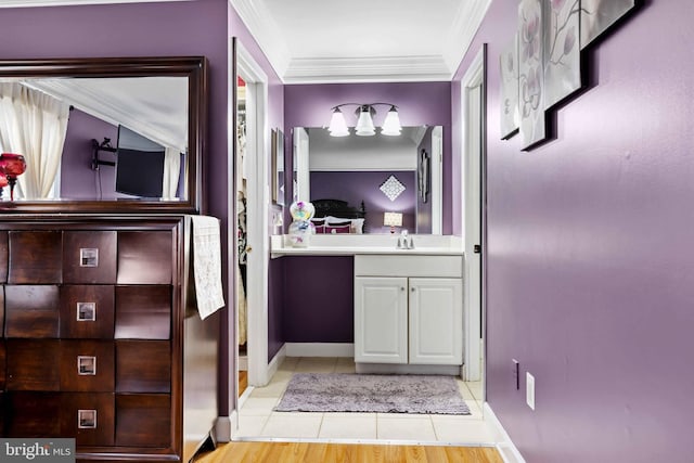 bathroom featuring vanity, tile patterned flooring, and crown molding