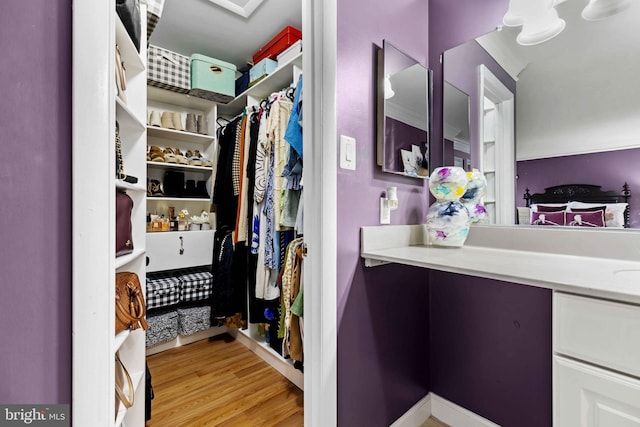 spacious closet with light hardwood / wood-style floors