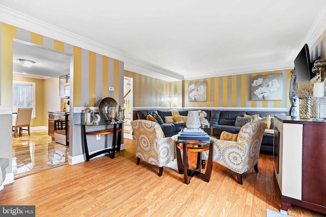 living room featuring light wood-type flooring and ornamental molding