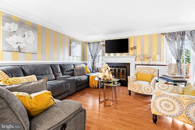 living room with crown molding, a wealth of natural light, and wood-type flooring