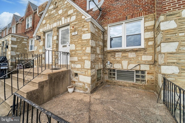 exterior space with stone siding