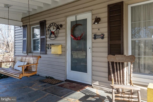 doorway to property with a porch