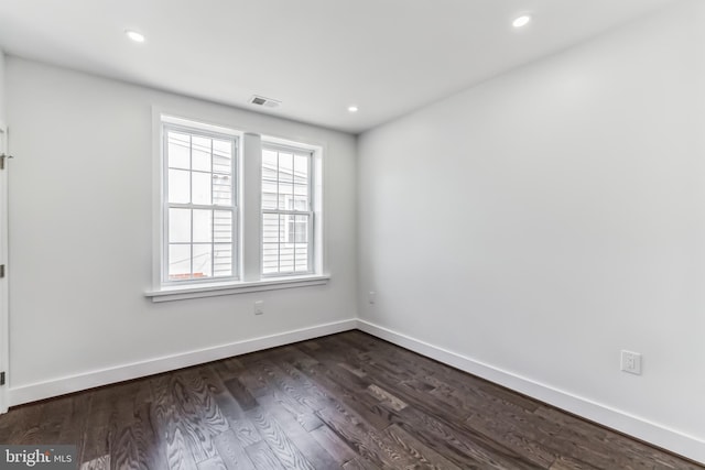 spare room with dark wood-type flooring