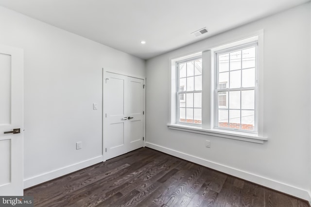 unfurnished bedroom featuring dark hardwood / wood-style flooring