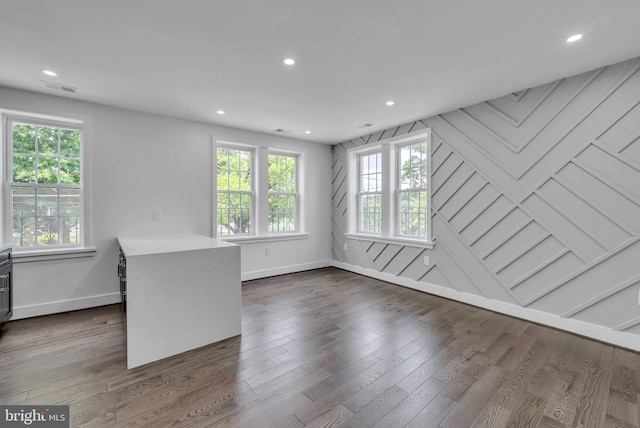 interior space with baseboards, dark wood finished floors, visible vents, and recessed lighting