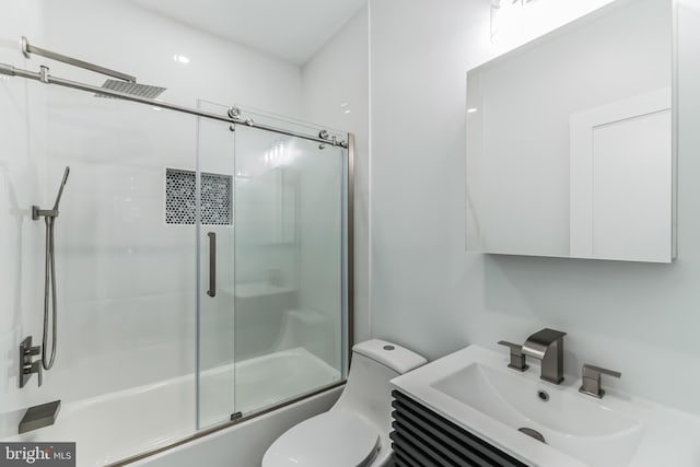 full bathroom featuring toilet, vanity, and combined bath / shower with glass door