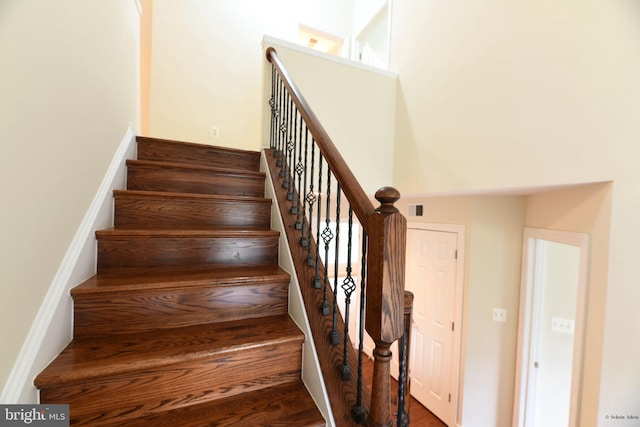 stairs featuring a high ceiling