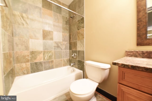 full bathroom with toilet, vanity, and tiled shower / bath combo