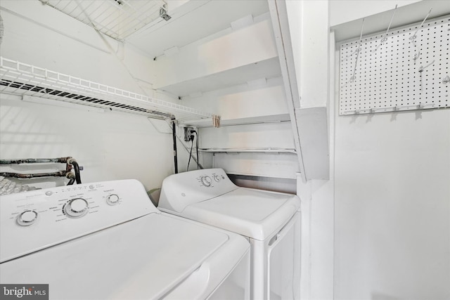 clothes washing area with laundry area and washer and clothes dryer