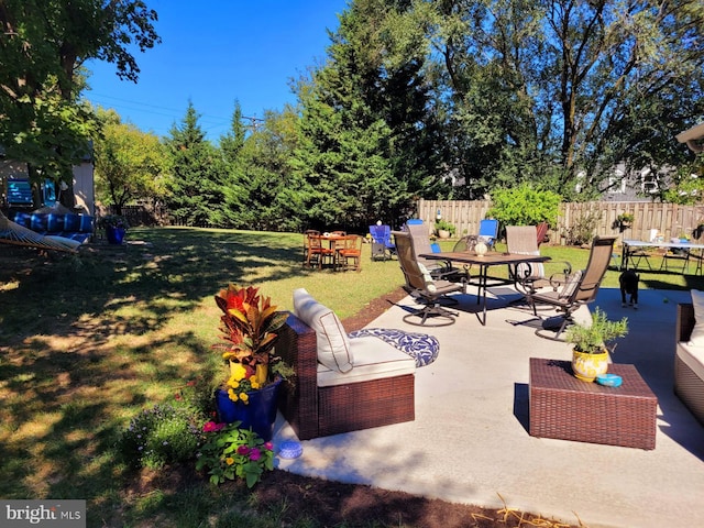 view of patio with fence and outdoor dining space