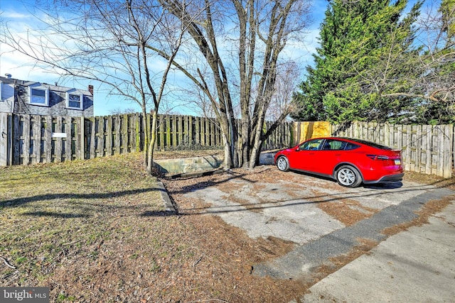 view of parking featuring fence