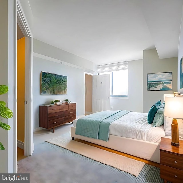 bedroom with baseboards and light colored carpet