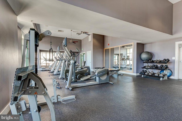 gym featuring high vaulted ceiling, a wealth of natural light, visible vents, and baseboards