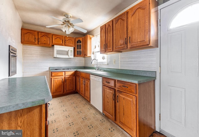 kitchen with sink, white appliances, tasteful backsplash, and ceiling fan