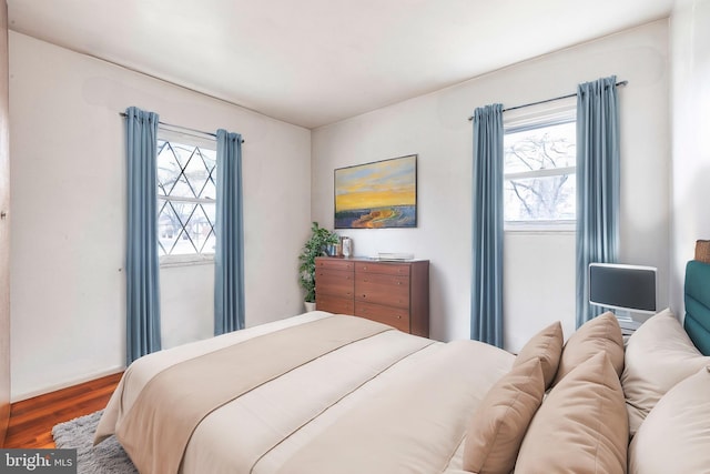 bedroom with hardwood / wood-style flooring