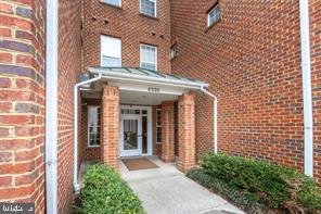 view of exterior entry featuring brick siding