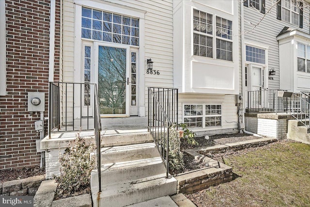 entrance to property featuring brick siding