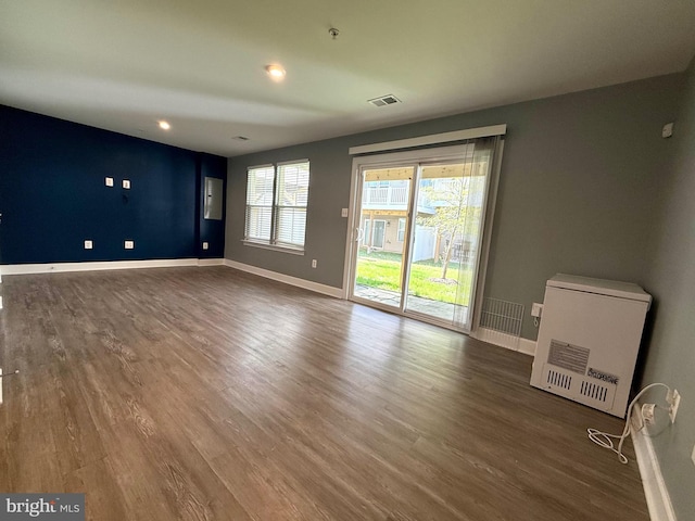 unfurnished living room featuring recessed lighting, baseboards, and wood finished floors