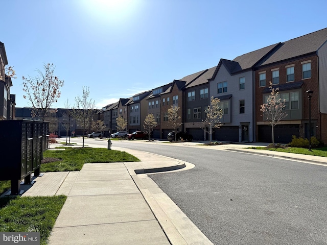 view of road featuring sidewalks, curbs, and a residential view