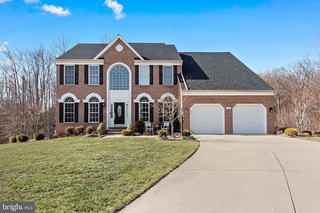 colonial home featuring driveway, an attached garage, a front lawn, and brick siding