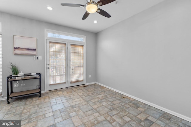 doorway to outside featuring recessed lighting, stone finish flooring, ceiling fan, and baseboards