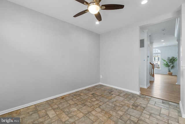 empty room with stone finish flooring, visible vents, baseboards, and recessed lighting