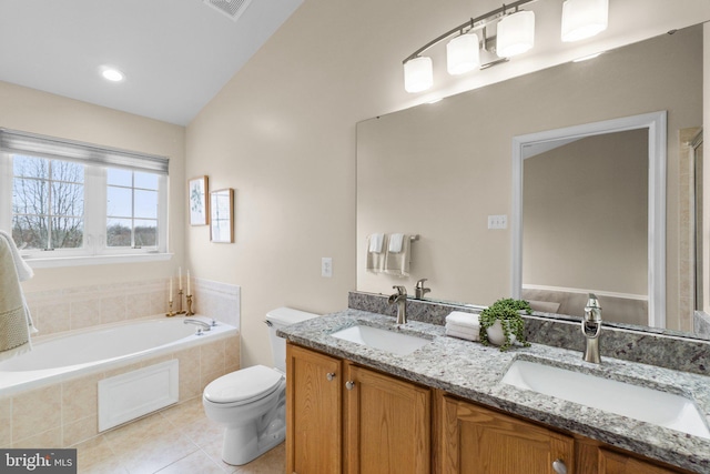 full bath featuring toilet, double vanity, a sink, and a bath