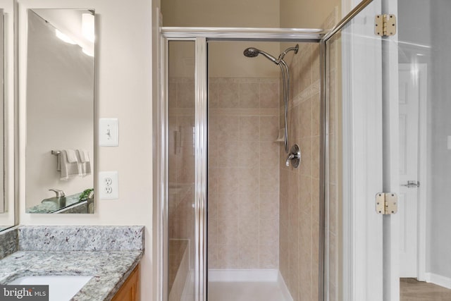 full bath featuring a stall shower and vanity