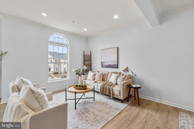 living area featuring crown molding, light wood-style flooring, and baseboards