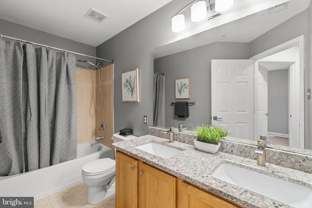 bathroom with visible vents, shower / bath combo with shower curtain, a sink, and tile patterned floors